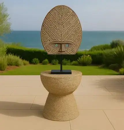 Decorative mask on a stand with a scenic background