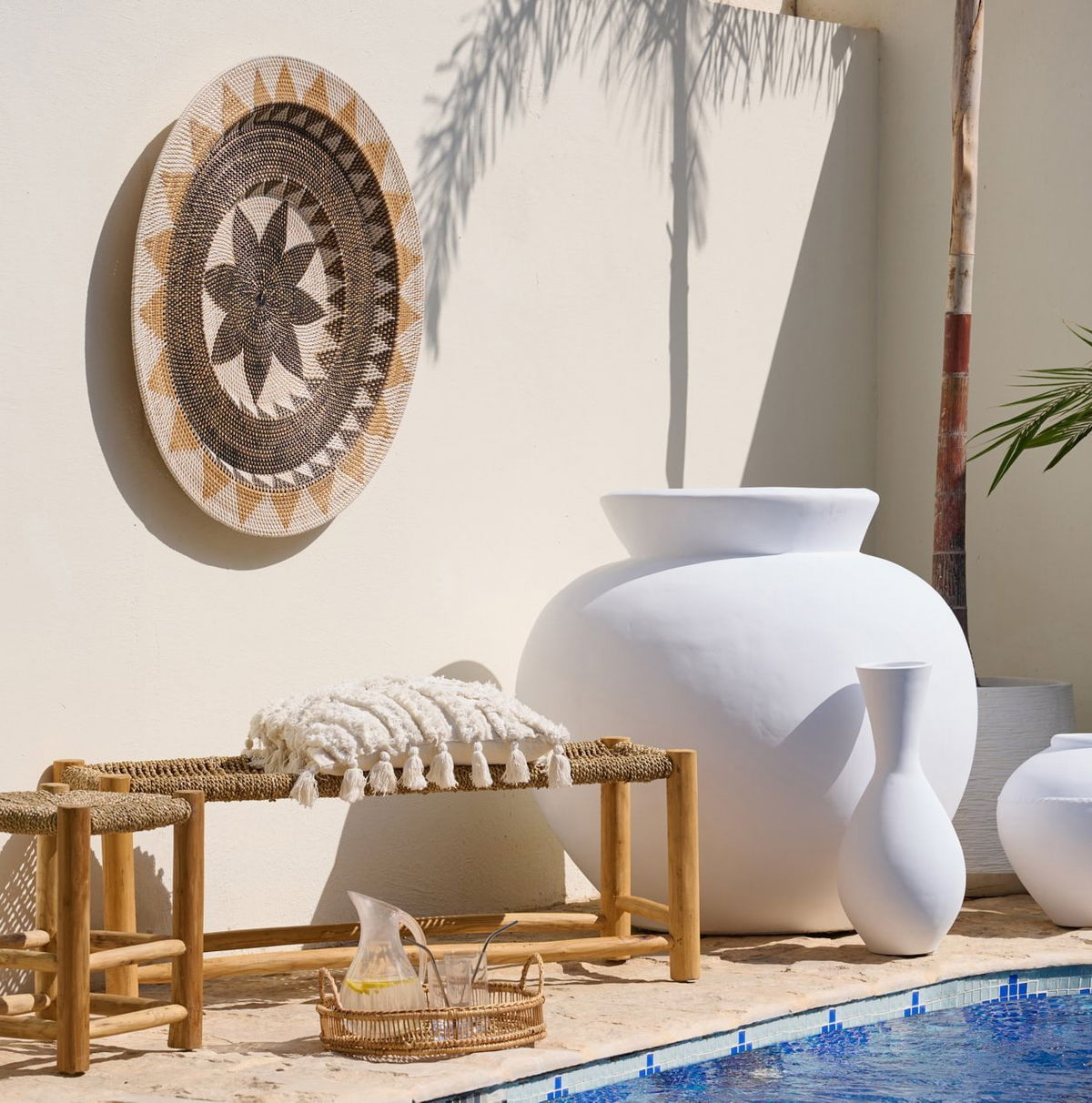 Outdoor accessories styled on a Dubai patio with rug, cushions and lamp