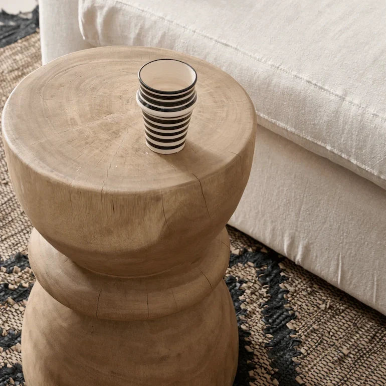 Wooden and concrete side tables in a styled Dubai living room