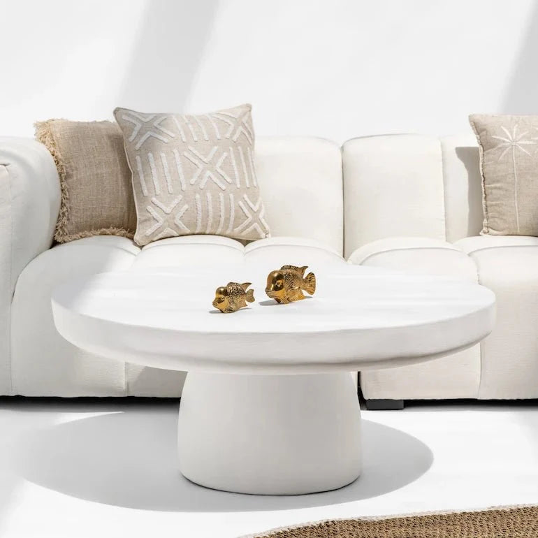 Stone coffee table in a neutral Dubai living room with linen sofa