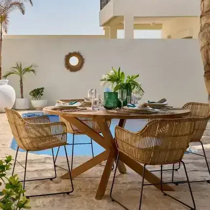 Rattan and wooden dining chairs at a styled table - dining chairs Dubai