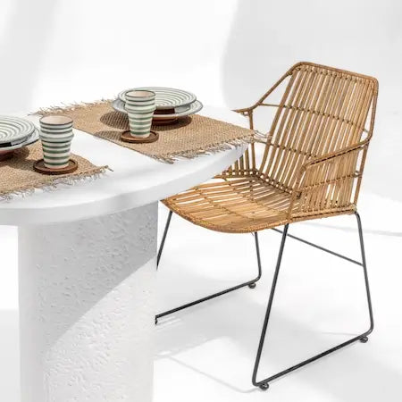 How to clean rattan furniture shown on a woven chair in a UAE home
