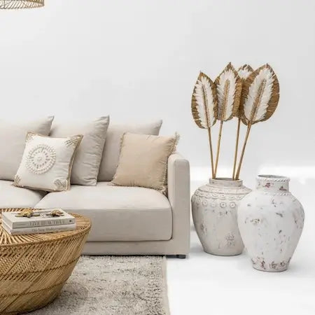 Boho home decor in Dubai with large white floor vases and linen sofa
