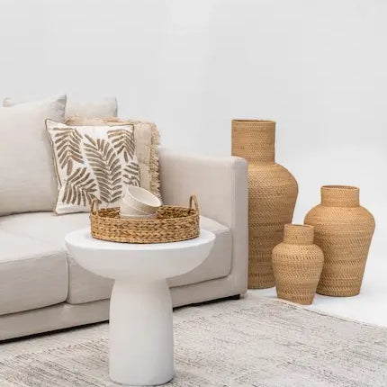  Boho living room with linen sofa, white side table and rattan basket vases