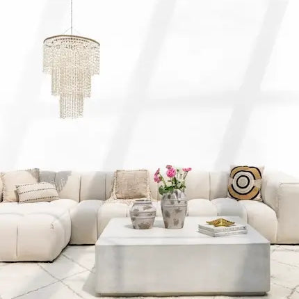 Modular sofa with capiz shell chandelier and concrete coffee table in Dubai