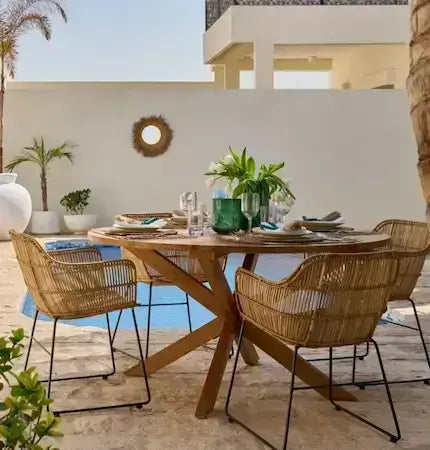 Outdoor wooden dining table with rattan chairs