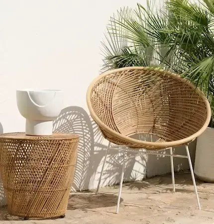 Wicker chair and side table on a wooden deck