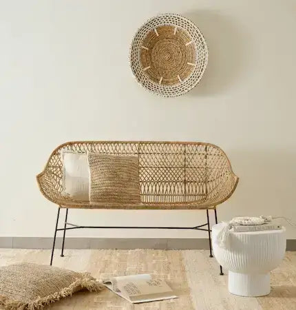 Rattan bench with cushions and woven wall decor