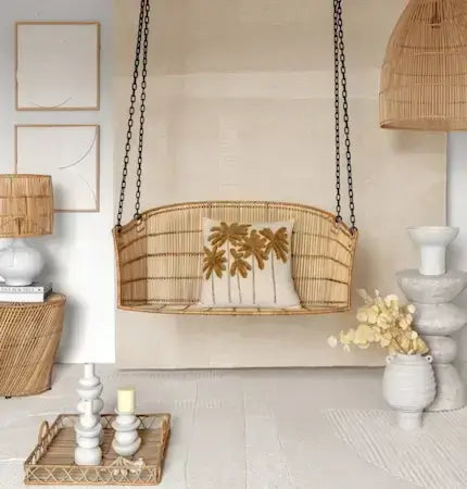 Rattan swing chair styled in neutral boho interior Dubai