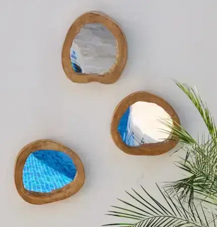 Round wooden frame mirrors on white wall