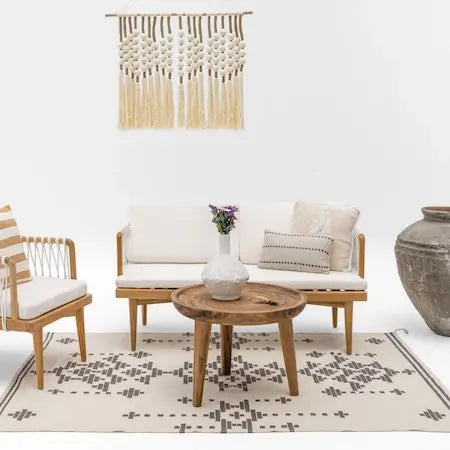 Teak wooden sofa set with macrame wall hanging, wood coffee table and stone vase