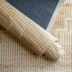 Woven neutral rug in natural fibers with geometric texture